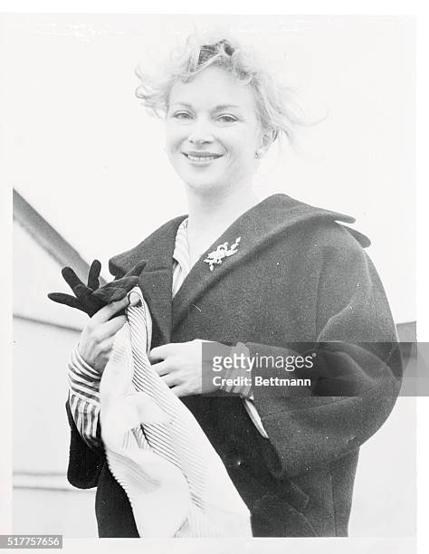 British actress Joan Greenwood is more than slightly windblown, but still attractive, as she arrives at London Airport. Miss Greenwood is on hand for...