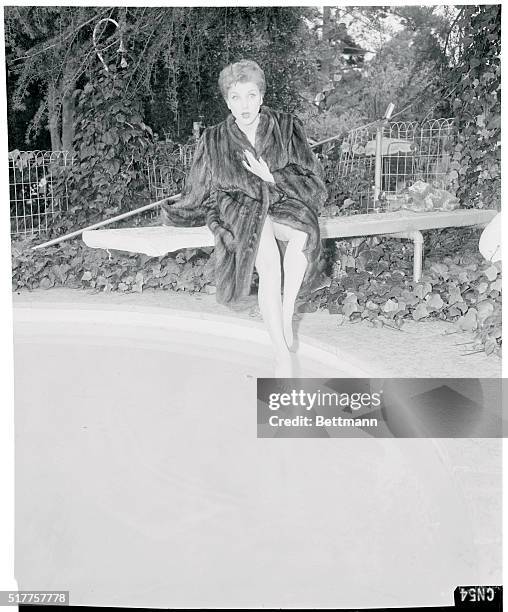 Mink coat over her swimsuit, Debra poses for a Hollywood type glamour shot at her pool. After all, what's a movie star without a swimming pool -- eh?