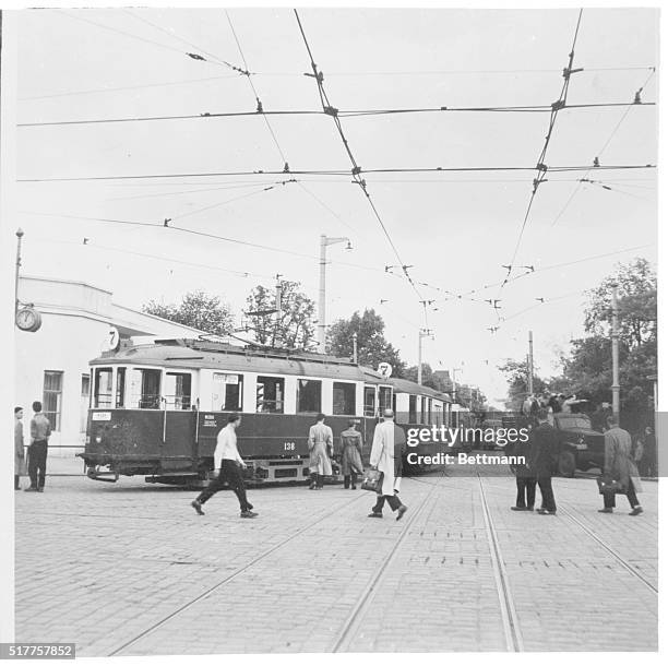 Polish Revolt Continues. Poznan, Poland: Deserted street cars lie at a standstill as rioting workers pass by in trucks near the Poznan trade fair...