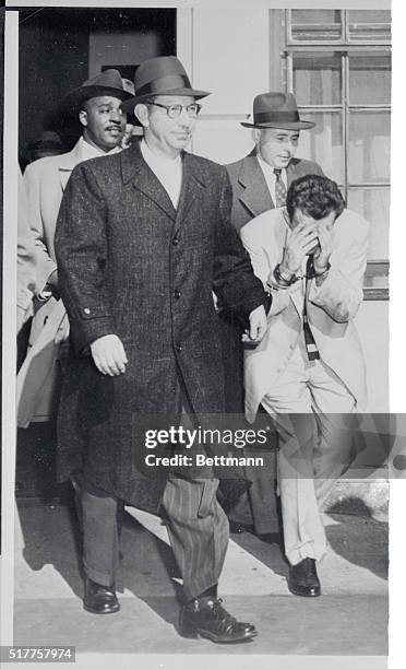 "Trigger' Burke Examined at Bellevue. New York, New York: Elmer "Trigger" Burke leaves Bellevue Hospital's psychiatric building in custody of...