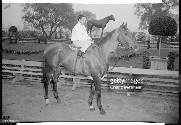 Famous pair, Swaps with Willie Shoemaker up, poses at the Santa Anita Race Track with the statue of the great Seabiscuit in the background, as they...