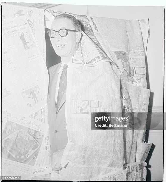 Senator Estes Kefauver smilingly breaks through the "Newspaper Curtain," as he pays a surprise visit to Miami. The Democratic Presidential aspirant...