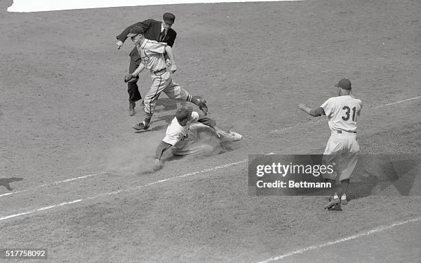 Duke Snider of the Brooklyn Dodgers is shown sliding safely into first base in the seventh inning of the Dodgers-St. Louis Cards game at Ebbets...