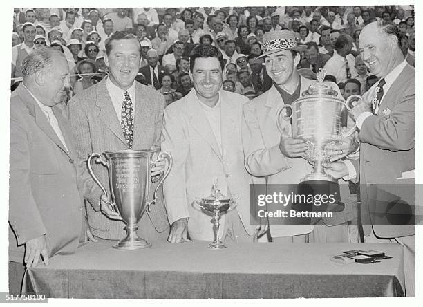 Sammy Snead won the PGA Golf Championship for the second time today with a 3 and 2 victory over Johnny Palmer. Shown left to right at the Cup...