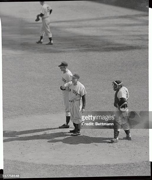 Stengal waves to bullpen for relif from Don Larson in second inning. Yogi Berra stands by.