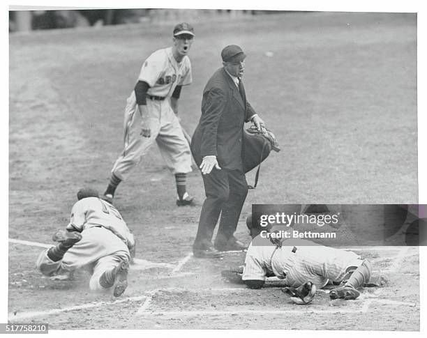 St. Louis Browns player, Roy Sievers, safe at home plate. Catcher Yogi Berra is on ground after missing Sievers.