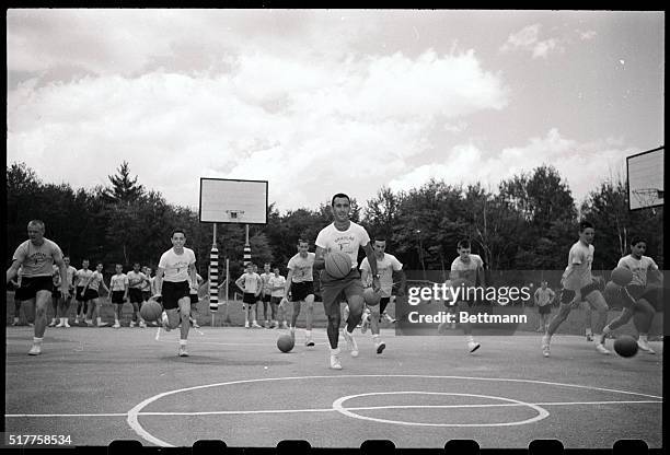 Kids are shown running down the court with basketballs at Bob Cousy's camp Greyleg in Pittsfield, NH, 7/7. Cousy heads up the group running in the...