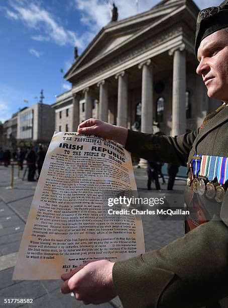 An Irish army commandant displays the Irish republic's proclamation during the 1916 Easter Rising commemoration parade marking the 100th anniversary...