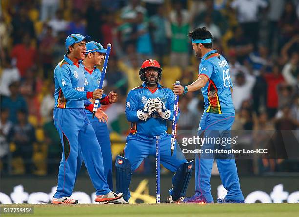 Usman Ghani, Amir Hamza, Mohammad Shahzad and Hamid Hassan of Afghanistan celebrate their victory during the ICC World Twenty20 India 2016 Group 1...