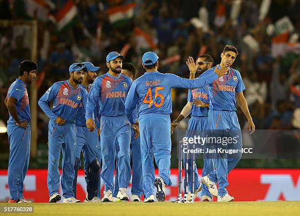 Ashish Nehra of India celebrates the wicket of Usman Khawaja of Australia with team mates during the ICC World Twenty20 India 2016 Super 10s Group 2...