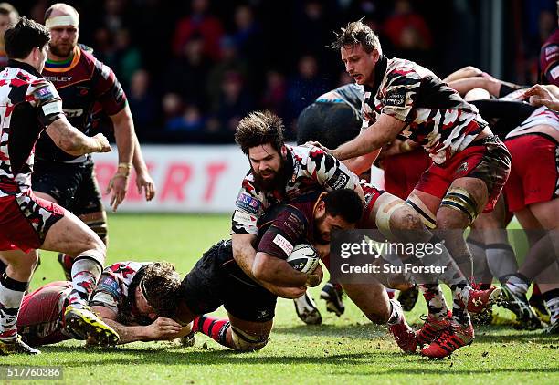 Dragons player Taulupe Faletau is stopped just short of the try line by Cornell Du Preez of Edinburgh during the Guinness Pro 12 match between...