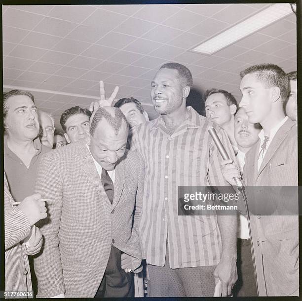 Montreal: Redd Fox of Los Angeles, is a friend indeed of light heavyweight champion Archie Moore . Who else would have an M shaved on top of his...