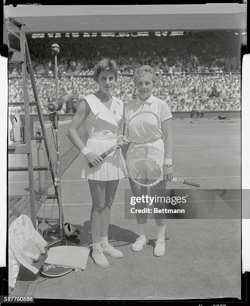 Miss Maria Bueno of Brazil and Miss Darlene Hard of the United states smile for courtside cameramen prior to their final round for the women's...