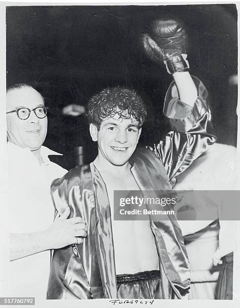 One gloved hand goes up in the traditional victory pose as Dai Dower, of Wales acknowledges cheers after winning the Flyweight Championship of the...