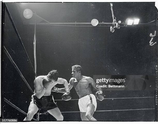 Floyd Patterson, Brooklyn light-heavyweight, lands a right to the body of Joe Gannon during their eight-rounder at the Garden tonight. Patterson,...