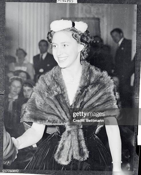 Britain's Princess Margaret is obviously having a wonderful time looking at the collection of Christian Dior fashions displayed at a recent showing...
