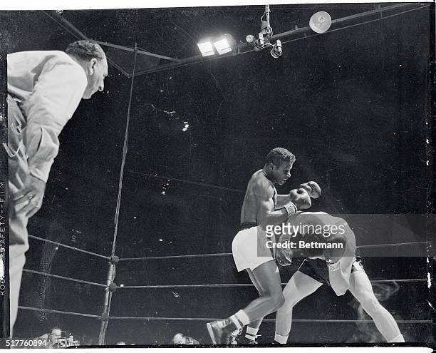 Joe Gannon of Washington, DC, ducks as Floyd Patterson, Brooklyn light-heavyweight misses, in the second round of their eight-rounder at the Garden...