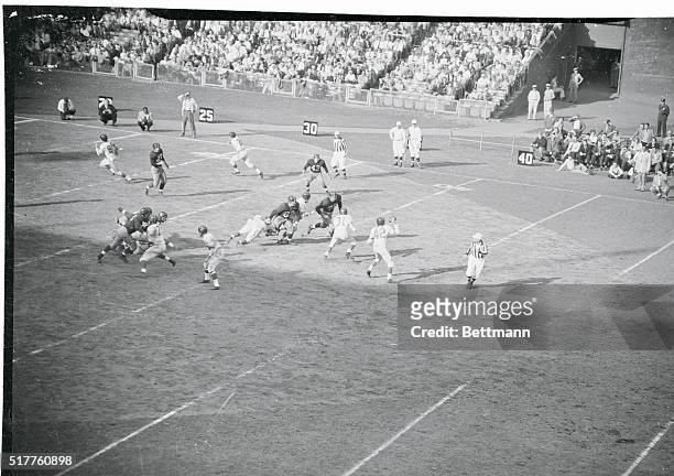 Charlie Conerly, , Giant quarterback, looks for a receiver on Washington's 45 yard line and picks out Buford Long for a touchdown pass in the second...