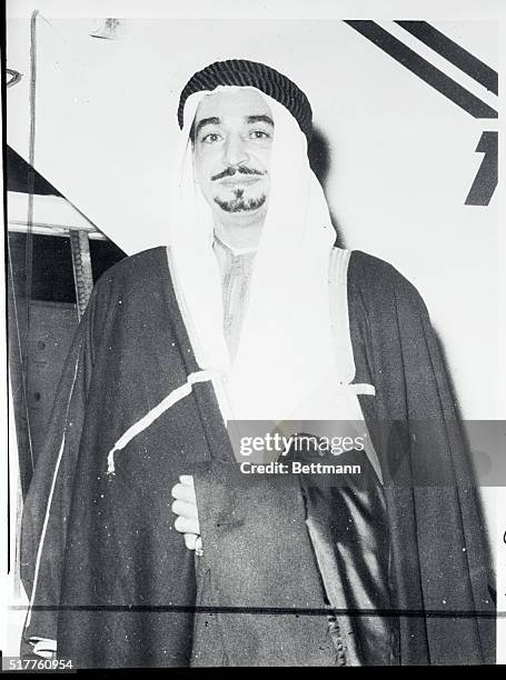 Wearing the traditional Burnoose, but carrying Western clothes, Sheikh Ezzat Gaafar, Chief of the Cabinet of the Emir of Kuwait, arrives in Cairo...