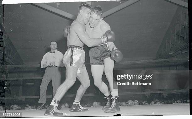The heads of Peter Mueller, German middleweight and Gene Fullmer collided as they mixed it up in the third round of their featured bout at Eastern...