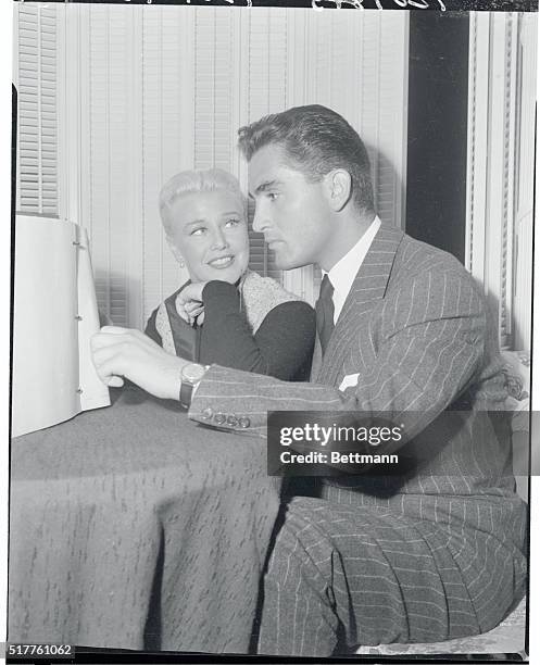 Glamorous Ginger Rogers has "that look" in her eyes for Jacques Bergerac when he visited her on the set of Paramount's Forever Female yesterday. The...