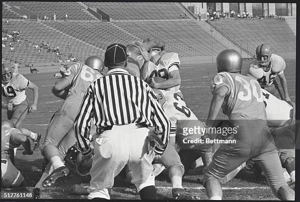 Los Angeles: Richard Easterly of Syracuse, blinded by arm of unidentified UCLA player, fights his way across goal line for the Orangeman's 3rd...