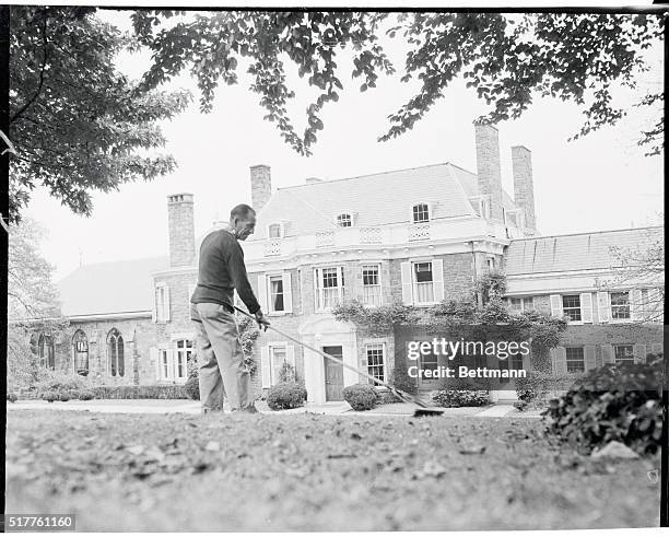 Gardener tidies up the grounds of Waves Hill, a 124 year old Georgian home overlooking the Hudson River, in preparation for the visit of Queen Mother...