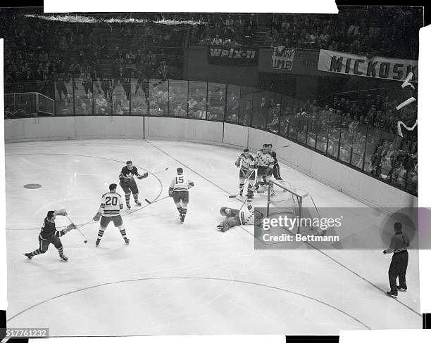 Puck goes whizzing by hard-trying Ranger goalie Lorne "Gump" Worsley into the nets for a Toronto Maple Leaf score in 3rd period of tonight's game at...