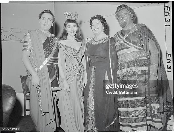 Costumed for their roles in Aida four Metropolitan Opera stars smile at the camera after a dress rehearsal for the Met opening Monday night. Left to...