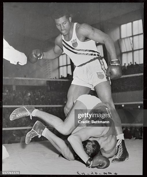 Sanders of the u.S. Is shown her knocking out Jost of Switzerland in the first round, during the boxing heavyweight elimination bout at Helsinki.