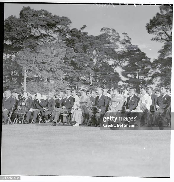 Emperor Hirohito and Empress Nagako are shown with other members of the Imperial family as they watched a court dance that featured the garden party...