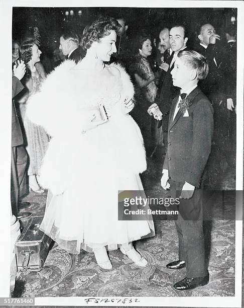 Year old Renzo Rossellini, son of director Roberto Rossellini, is shown with Miss Nucci Barbieri, his cousin, when they attended the Variety Club...