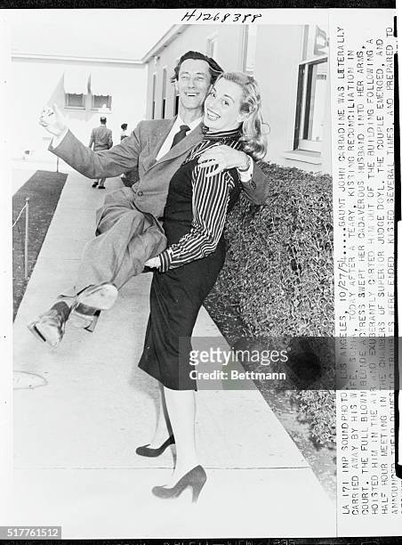 Cadaverous actor John Carradine is carried out of Los Angeles Superior Court in the arms of his blonde wife, Sonia. They were celebrating after...