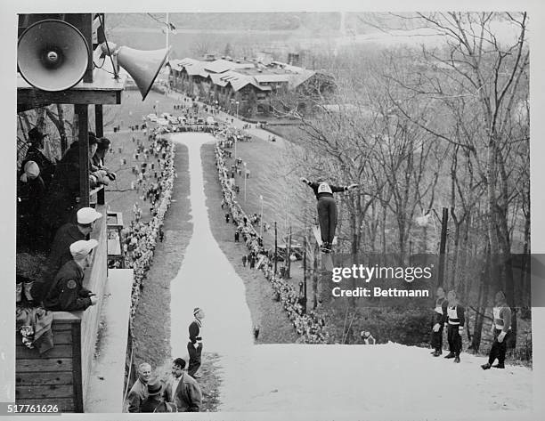 Art Devlin is shown as he took off in the picturesque mountain setting in today's 10th annual Torger Tokle Memorial Ski Jumping Meet here. Art, who...