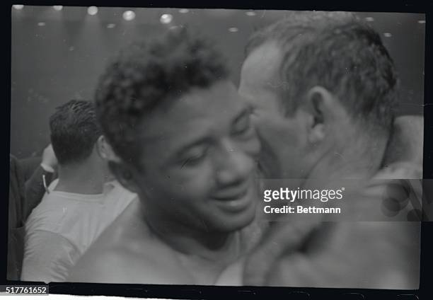 Grinning Floyd Patterson embraces defeated Ingemar Johansson after knocking him out in the sixth round of their title fight here.