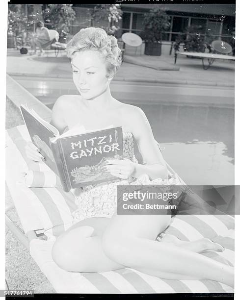 Even the honeymoon can get interrupted. Mitzi studies the script of the picture that will follow her current success in the 20th Century Fox musical,...