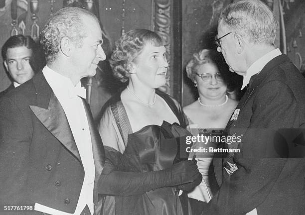 King Gustaf of Sweden, right, is shown as he greeted Nobel Prize winners and guests at the banquet held in the Golden Hall of the Stockholm Town Hall...