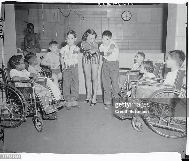 Aquatic Star Eleanor Holm donates one night a week to handicapped children, whom she teaches how to swim, at the Institute of Physical Medicine and...