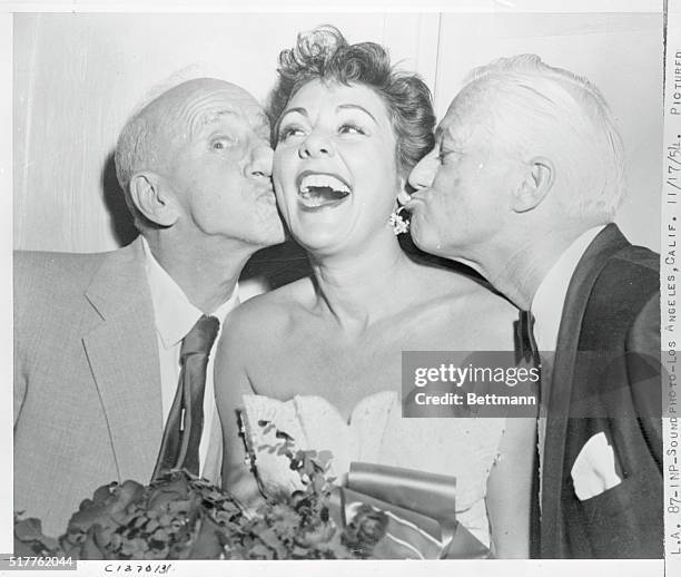 Los Angeles, California: Pictured backstage following her initial performance at Club Mocambo, Lilian Roth receives congratulations from Jimmy...