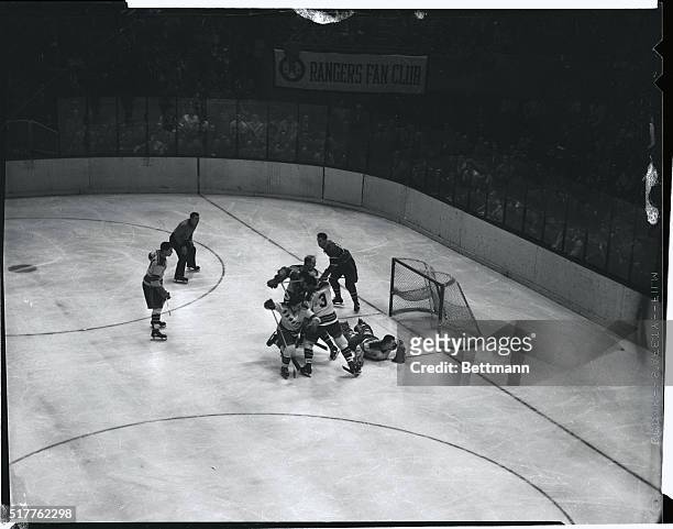 Host of Rangers hem in Canadiens' Maurice Richard as he tried to drive for a goal in the third period of tonight's game at the Garden. Ranger goalie...