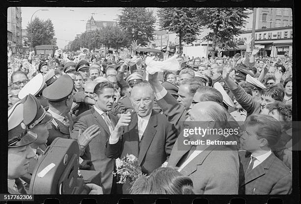 Adenauer at Marienfelde Refugee Camp. West Berlin, West Germany: Accompanied by Deputy Berlin Mayor Franz Amrehn West German chancellor Konrad...