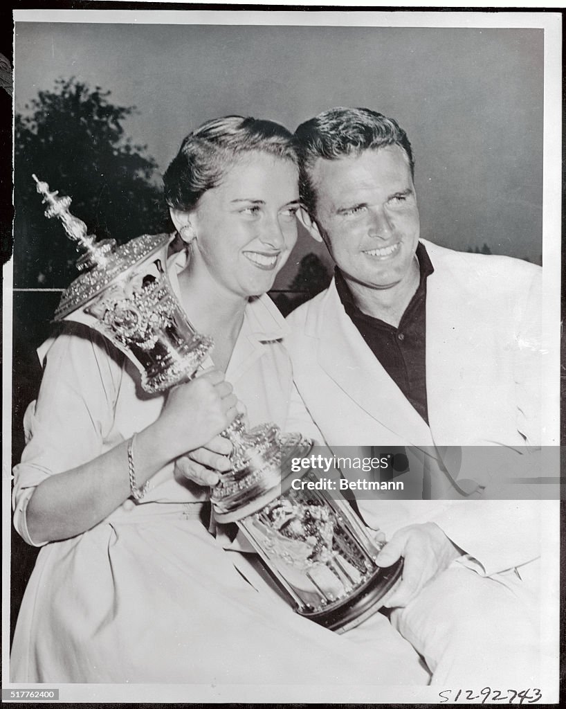 Harvie and Susan Ward Holding Golf Trophy