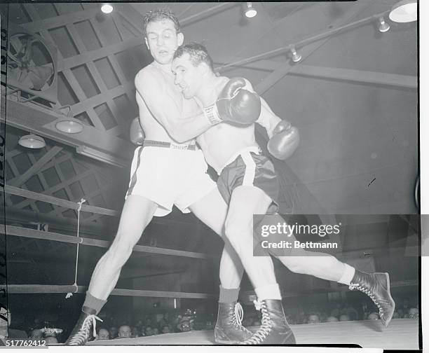 Paul Pender, , and Gene Fullmer dance into a clinch in the first round of their middleweight bout at the Eastern parkway Arena. Utah's undefeated...