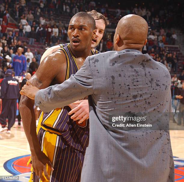 Ron Artest of the Indiana Pacers is restrained during a melee involving fans during a game against the Detroit Pistons November 19, 2004 at the...