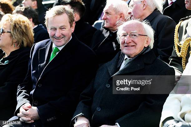 Acting Taoiseach Enda Kenny chats to President Michael D. Higgins at the Easter Sunday Commemoration Ceremony and Parade from OConnell Street on...