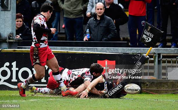 Dragons player Hallam Amos is stopped just short of the try line by Sam Beard of Edinburgh during the Guinness Pro 12 match between Newport Gwent...