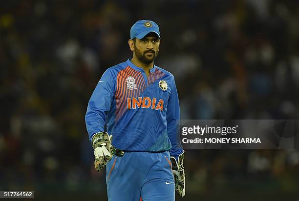 India's captain Mahendra Singh Dhoni walks off the pitch after the end of the Australian innings during the World T20 cricket tournament match...