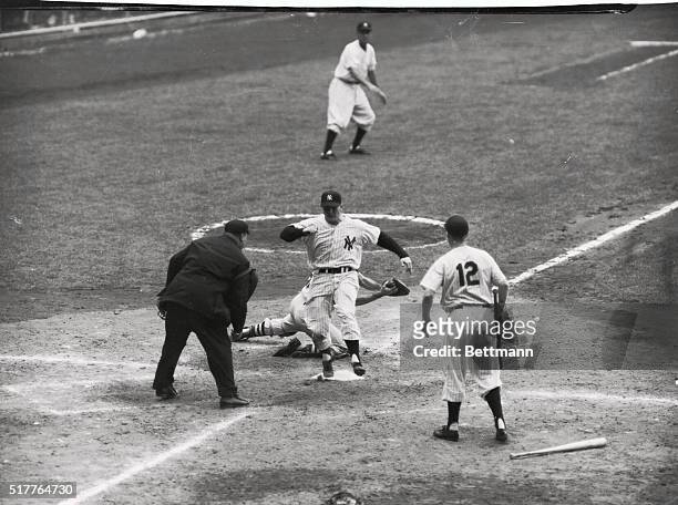 Mickey Mantle of the Yanks touches the plate after flying in from second base on Skowron's single in the fifth inning of today's game with the Boston...