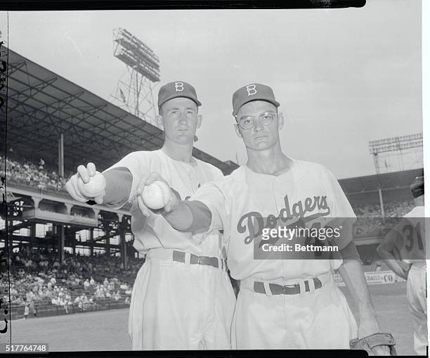 Brooklyn Dodgers pitchers Roger Craig and Don Bessent demonstrate a pitcher's grip on a baseball.
