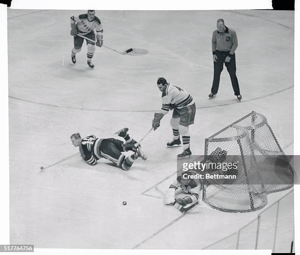 Rangers goalie Lorne Worsley and Bill Gadsby, , combined forces to prevent a scoring attempt by Dave Creighton, , of the Chicago Black Hawks. During...